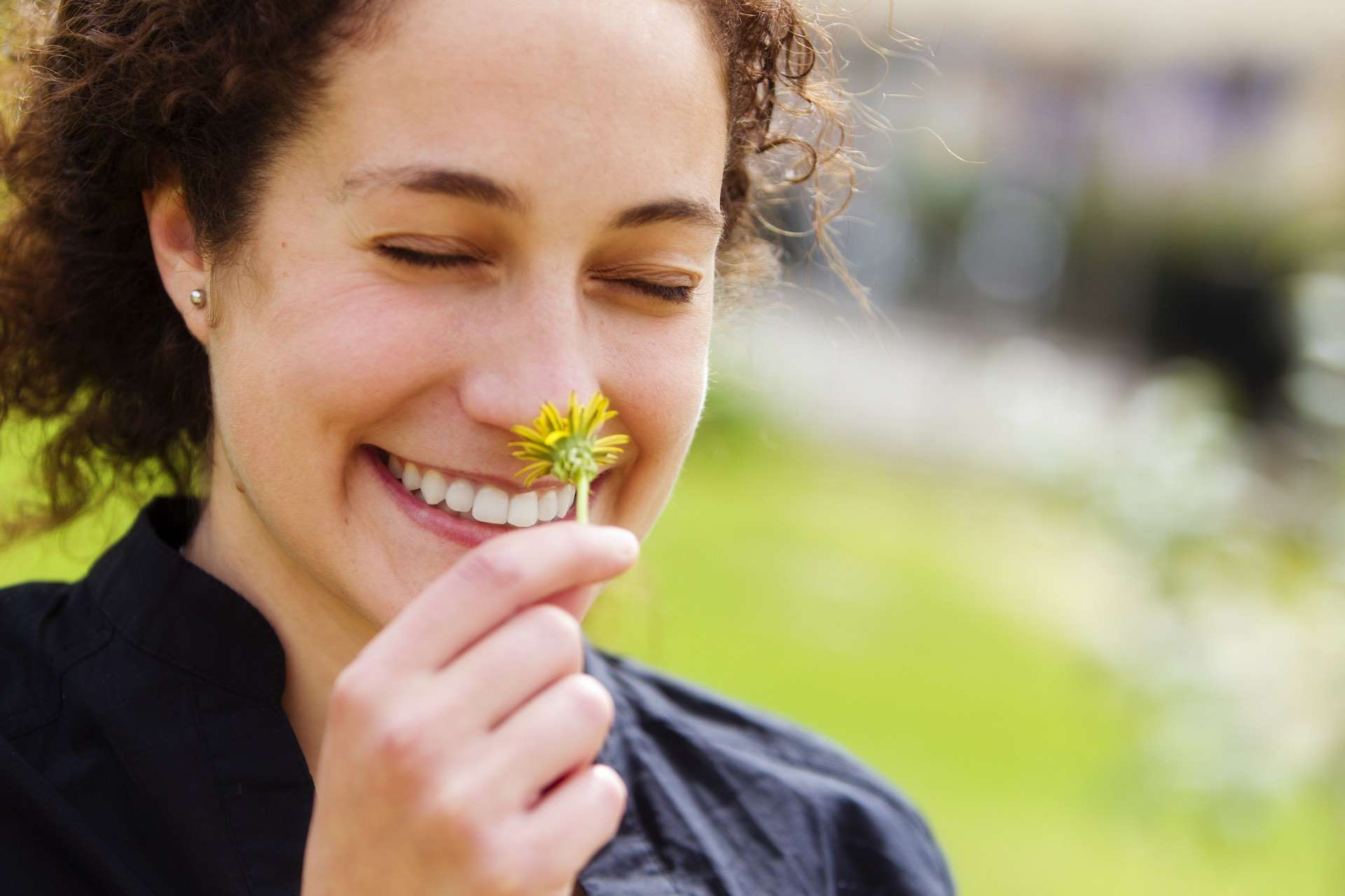 woman finding beauty in flower